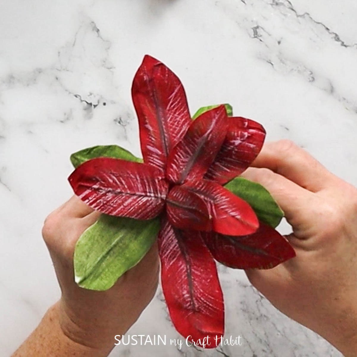 Christmas poinsettia crafted with masking tape, paint and floral wire.