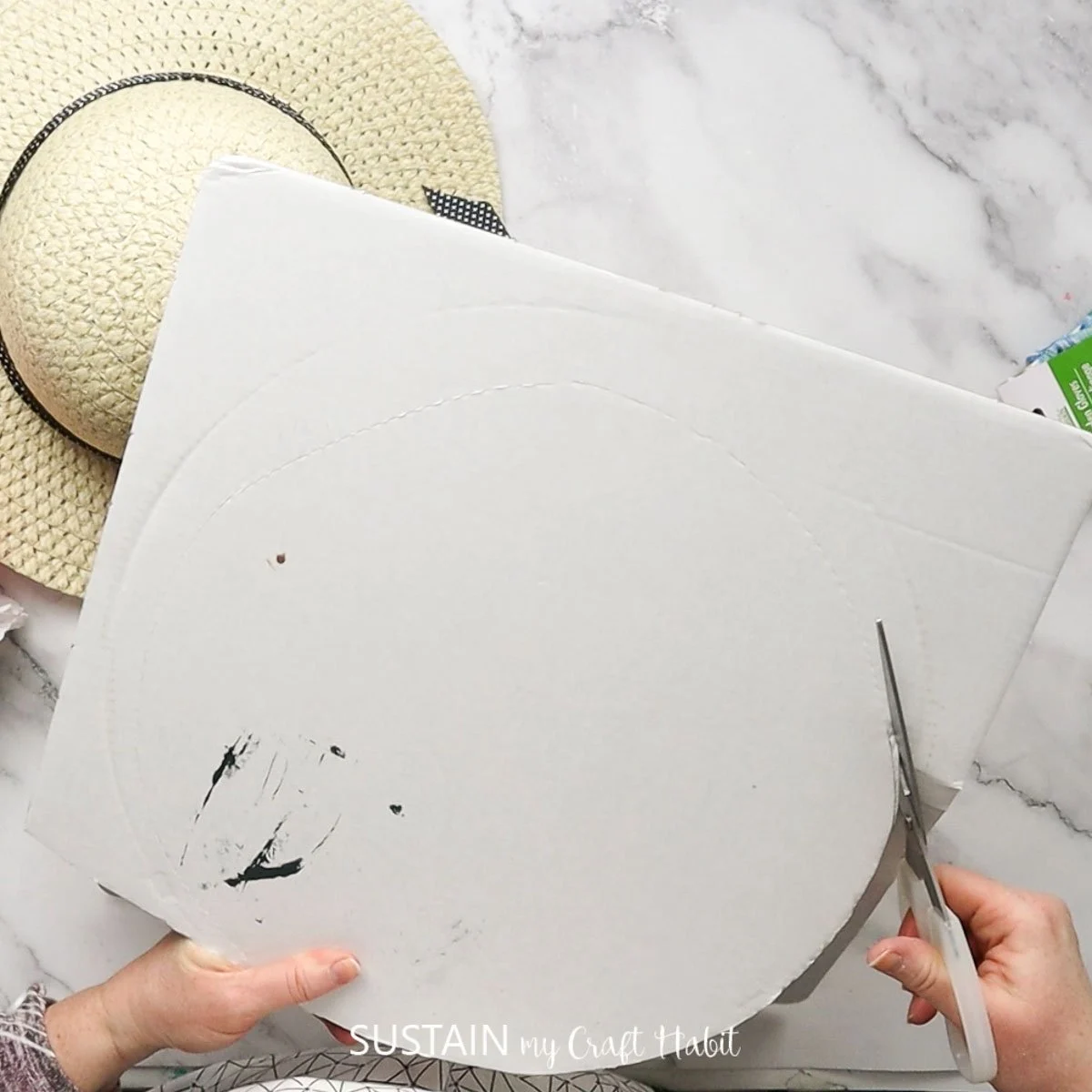 Cutting a piece of cardboard.