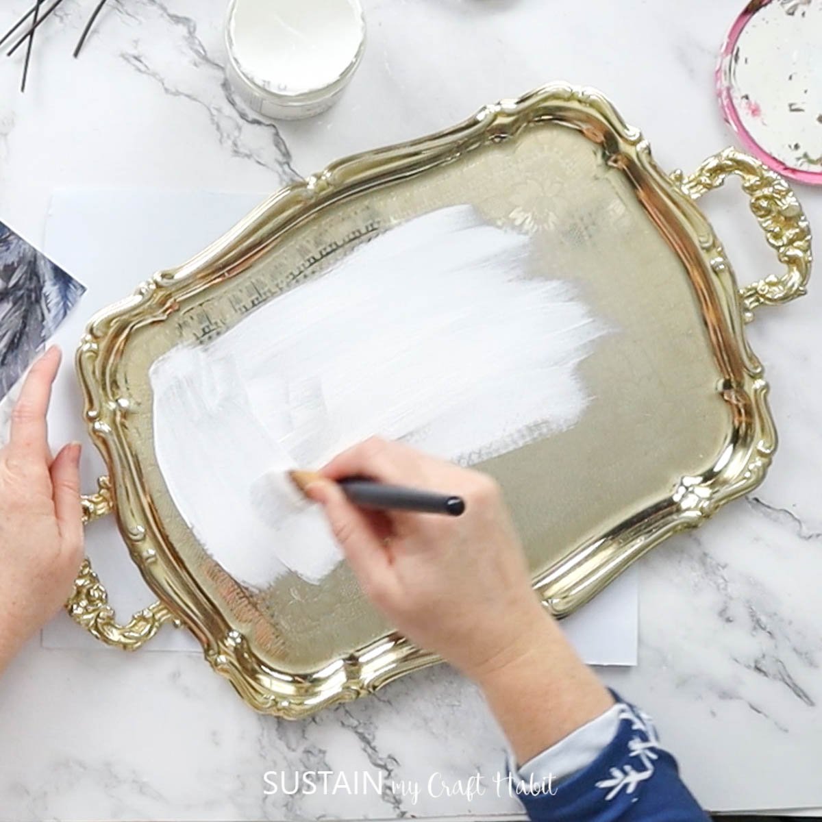 Painting a tray white. 
