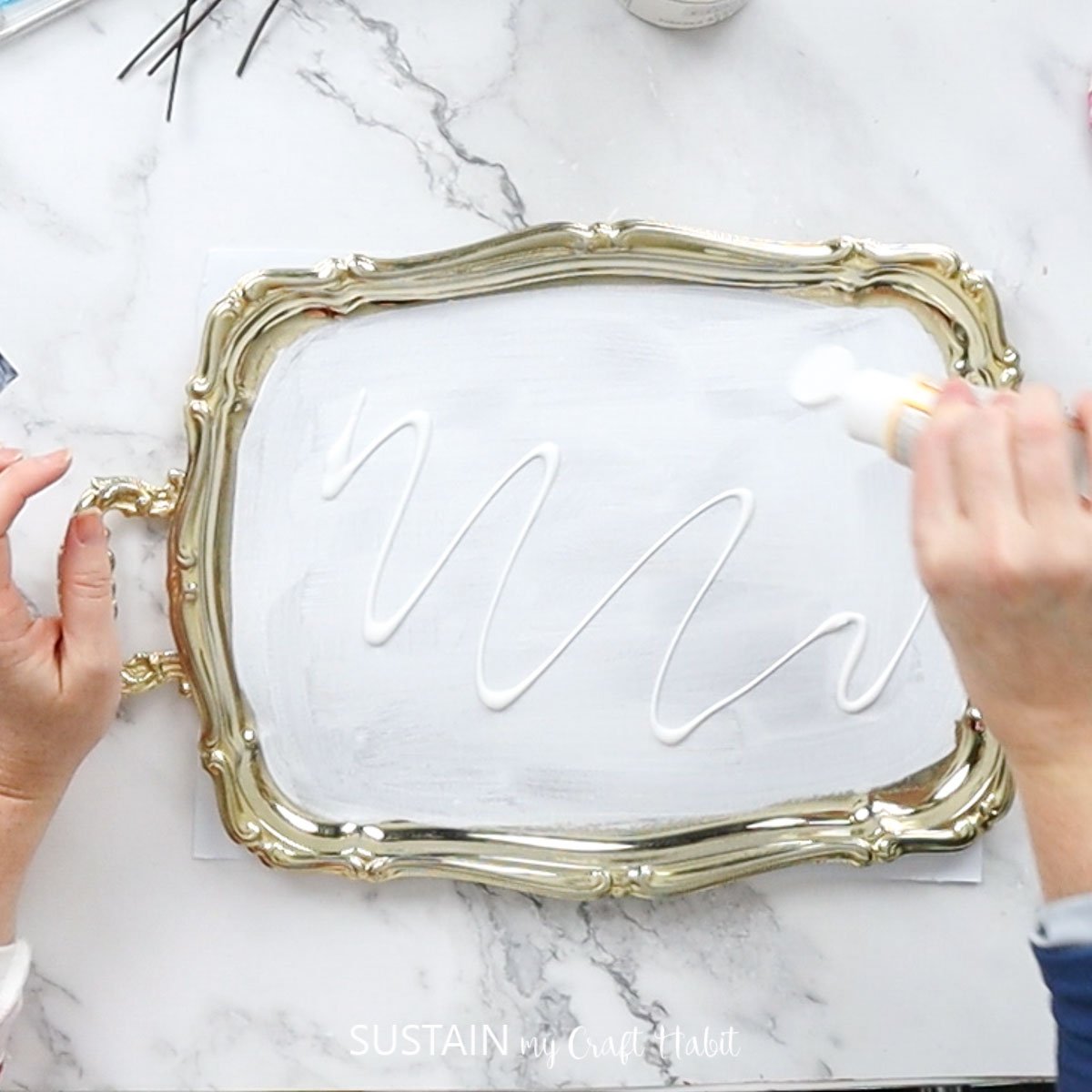 Adding Mod Podge over the painted tray. 