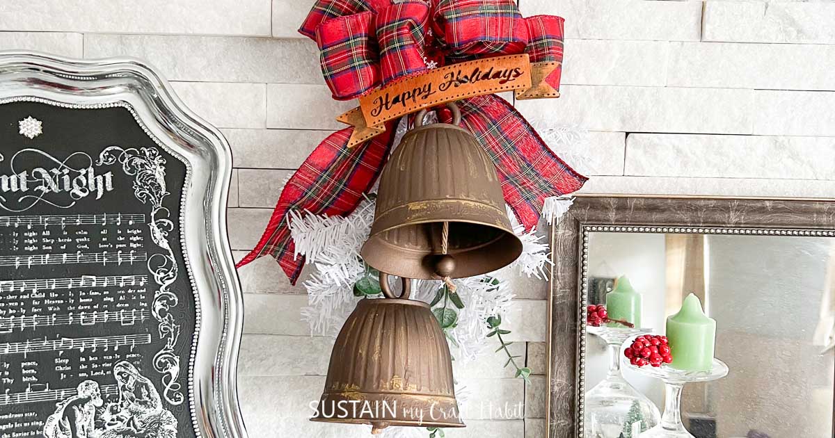 Plastic pots from the dollar store painted with brown and brass paint and hanging to mimic Christmas bells.