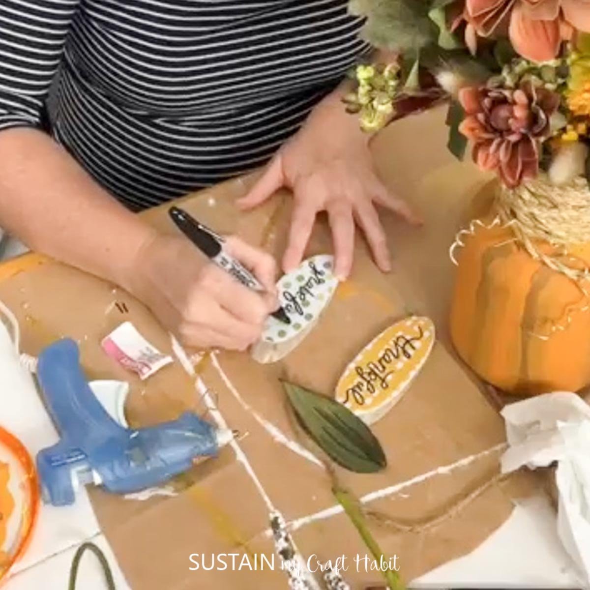 Woman writing words onto paper.