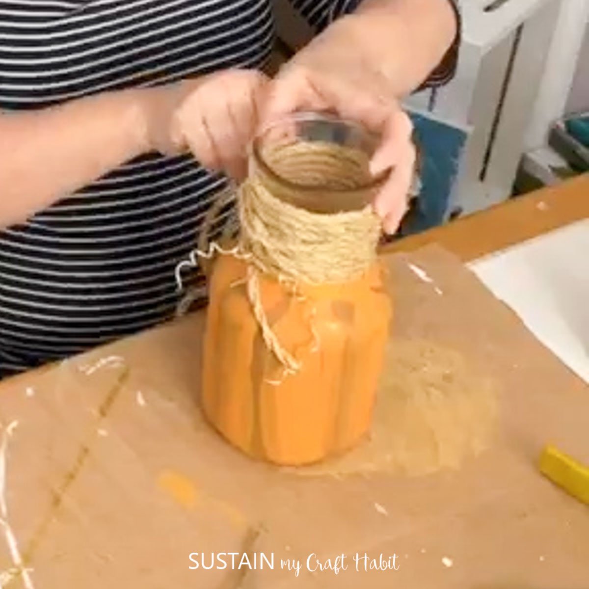 Wrapping Jute rope around a glass jar.