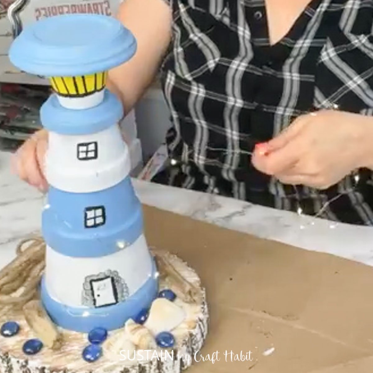 Stacked clay pots to make a lighthouse.