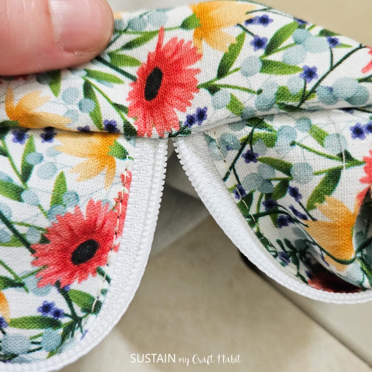 Showing edge of makeup bag with zipper open.