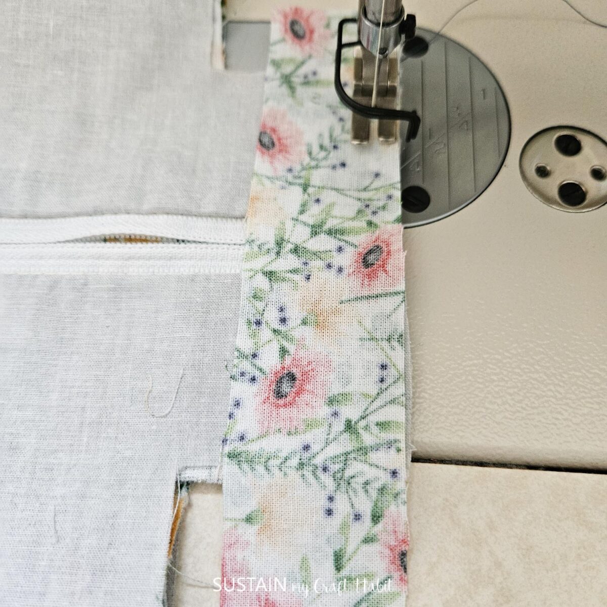 Sewing flower fabric to make up bag.