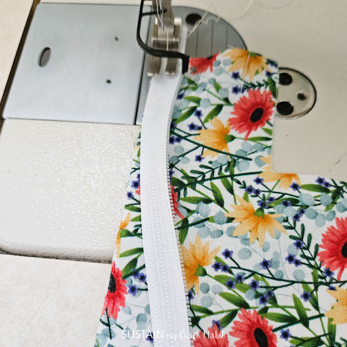 Sewing zipper onto fabric.