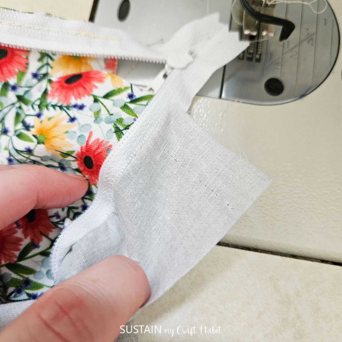 Sewing fabric attached to a zipper.