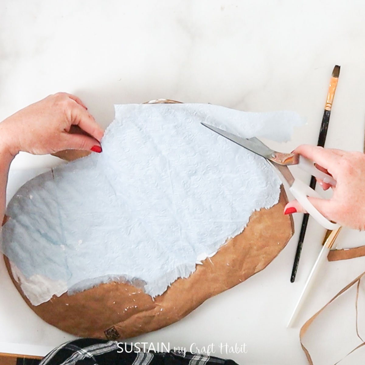 Cutting excess tissue paper.