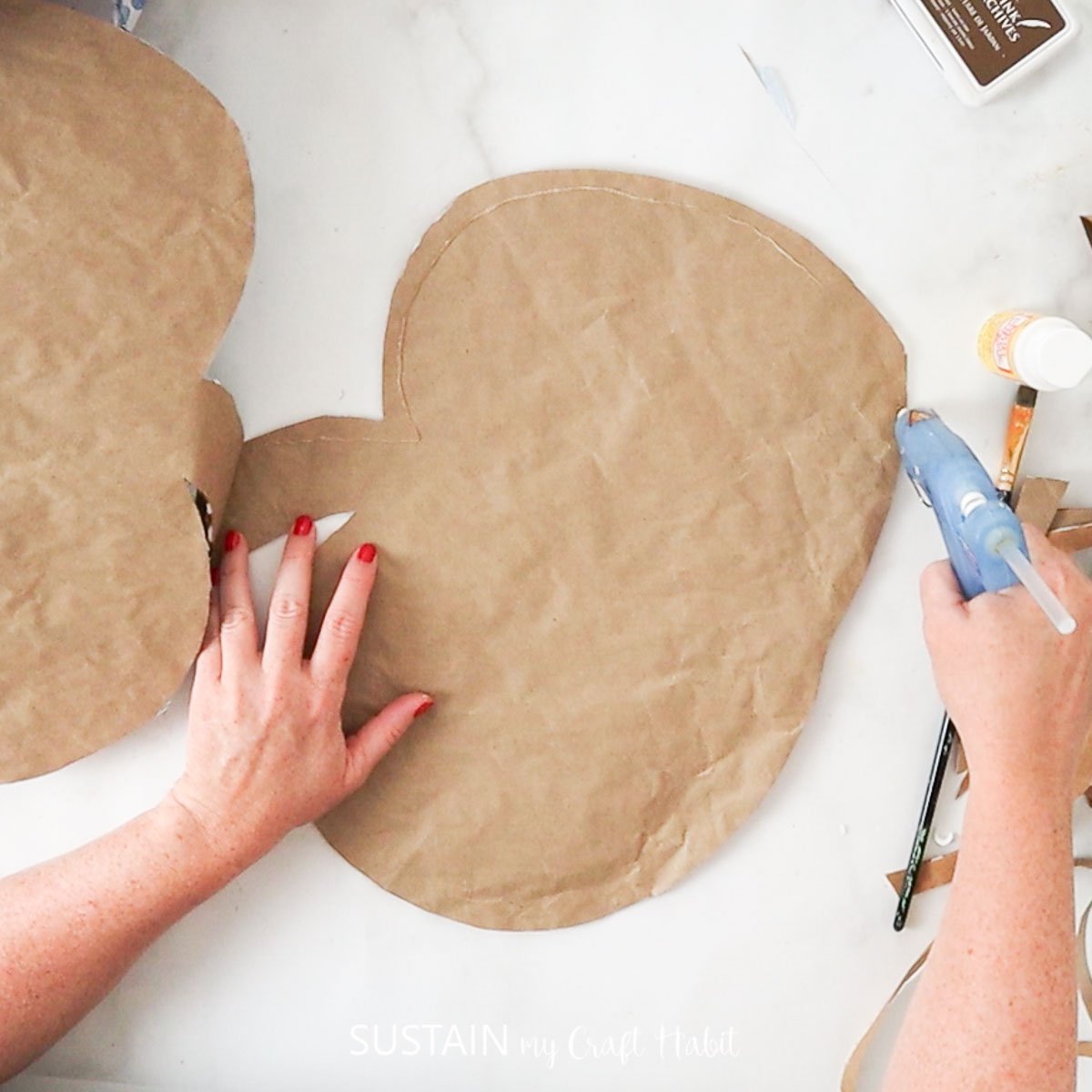 Adding hot glue on the edge of the pumpkin. 