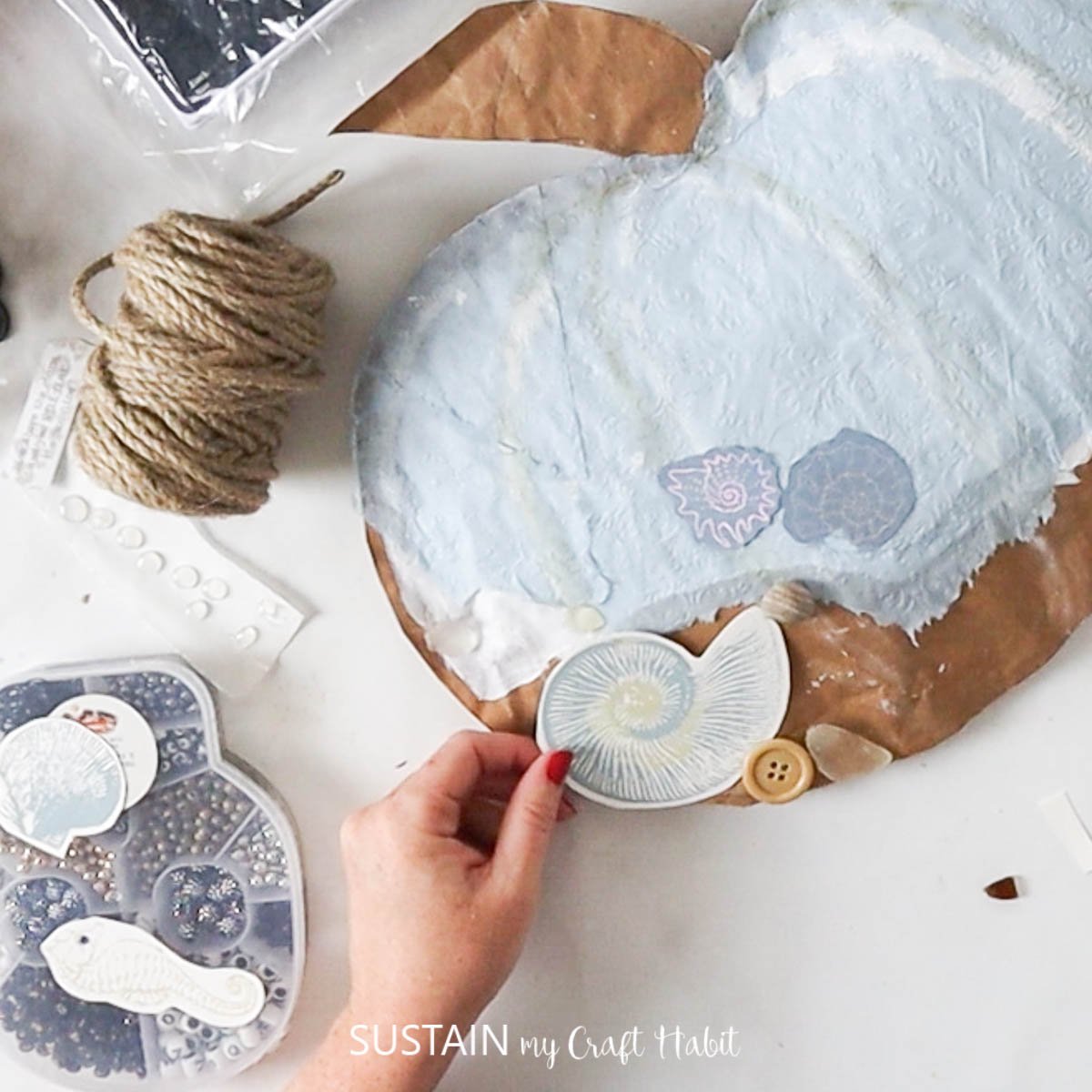 Hot gluing decorative embellishments. 