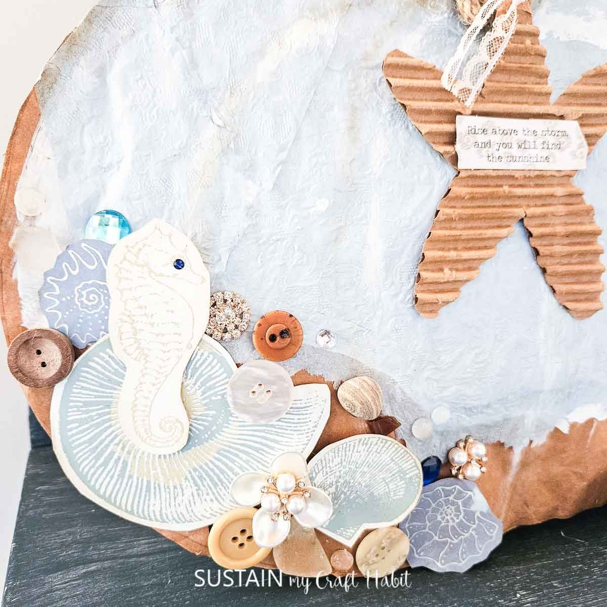 Coastal pumpkin decorated with embellishments. 