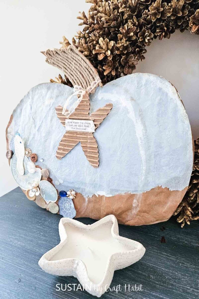 Coastal pumpkin made from packaging and decorated with paint, tissue paper and embellishments. 