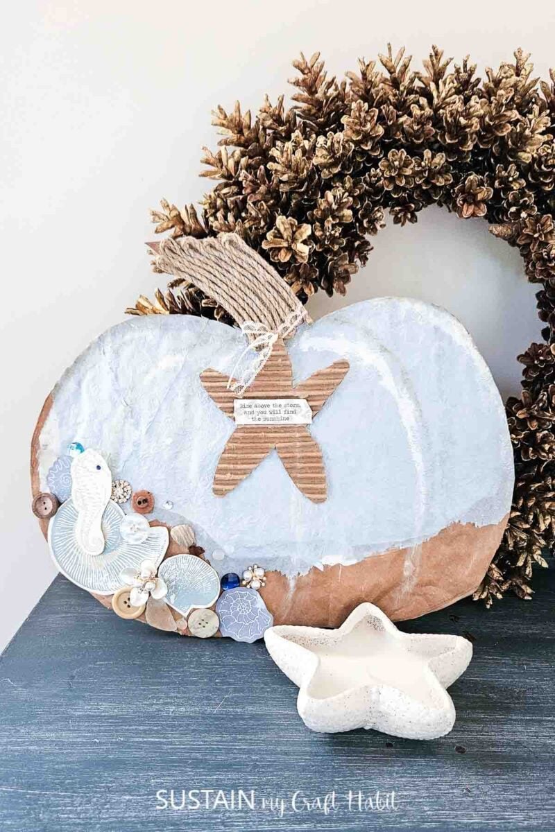 Coastal pumpkin made from packaging and decorated with paint, tissue paper and embellishments. 