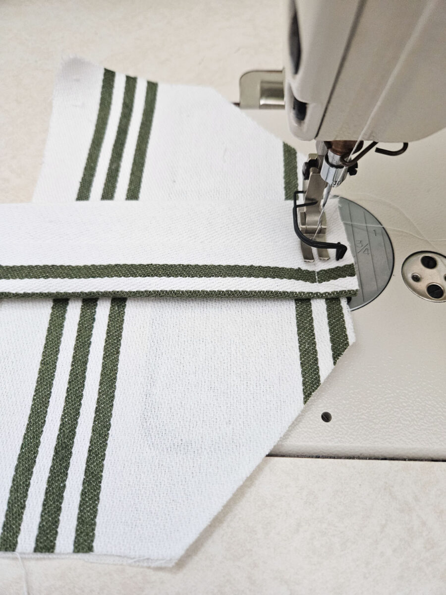 Stitching the elastic to the tea towel.