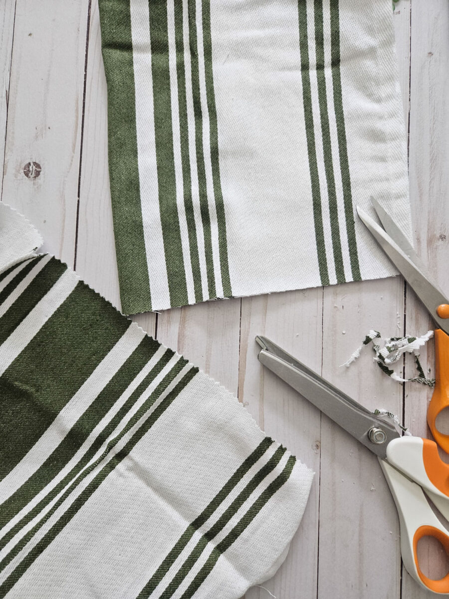 Cutting the edges of a tea towel.