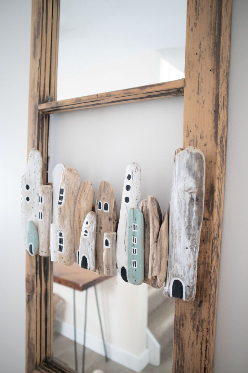 Mirror upcycled with a driftwood village.
