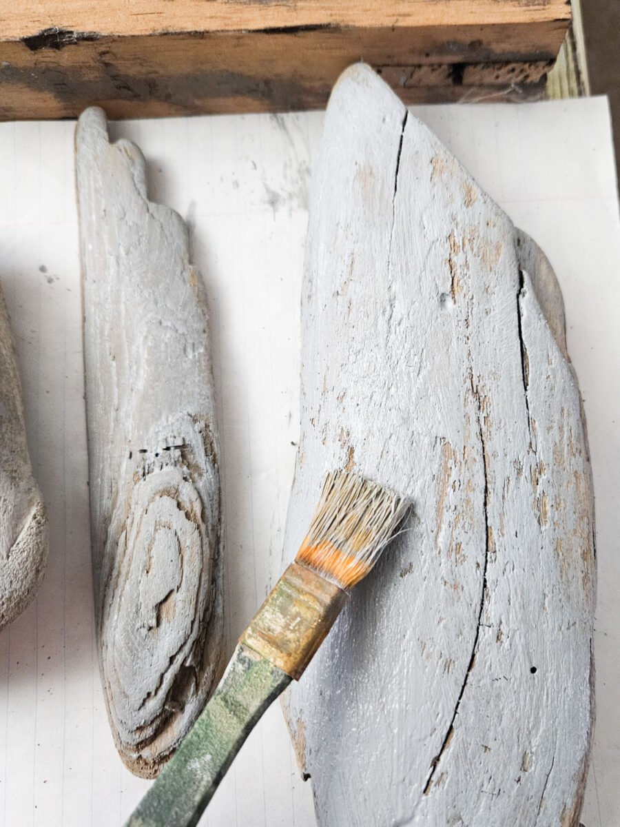 Painting pieces of driftwood.
