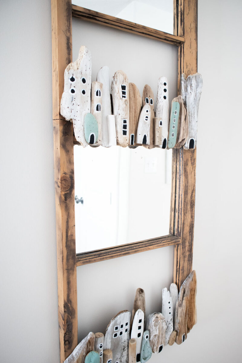 Mirror upcycled with a driftwood village.