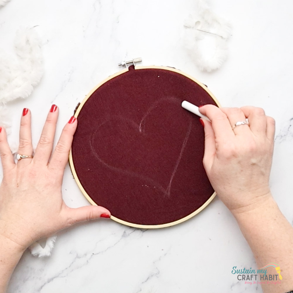 Using chalk to outline a heart shape.