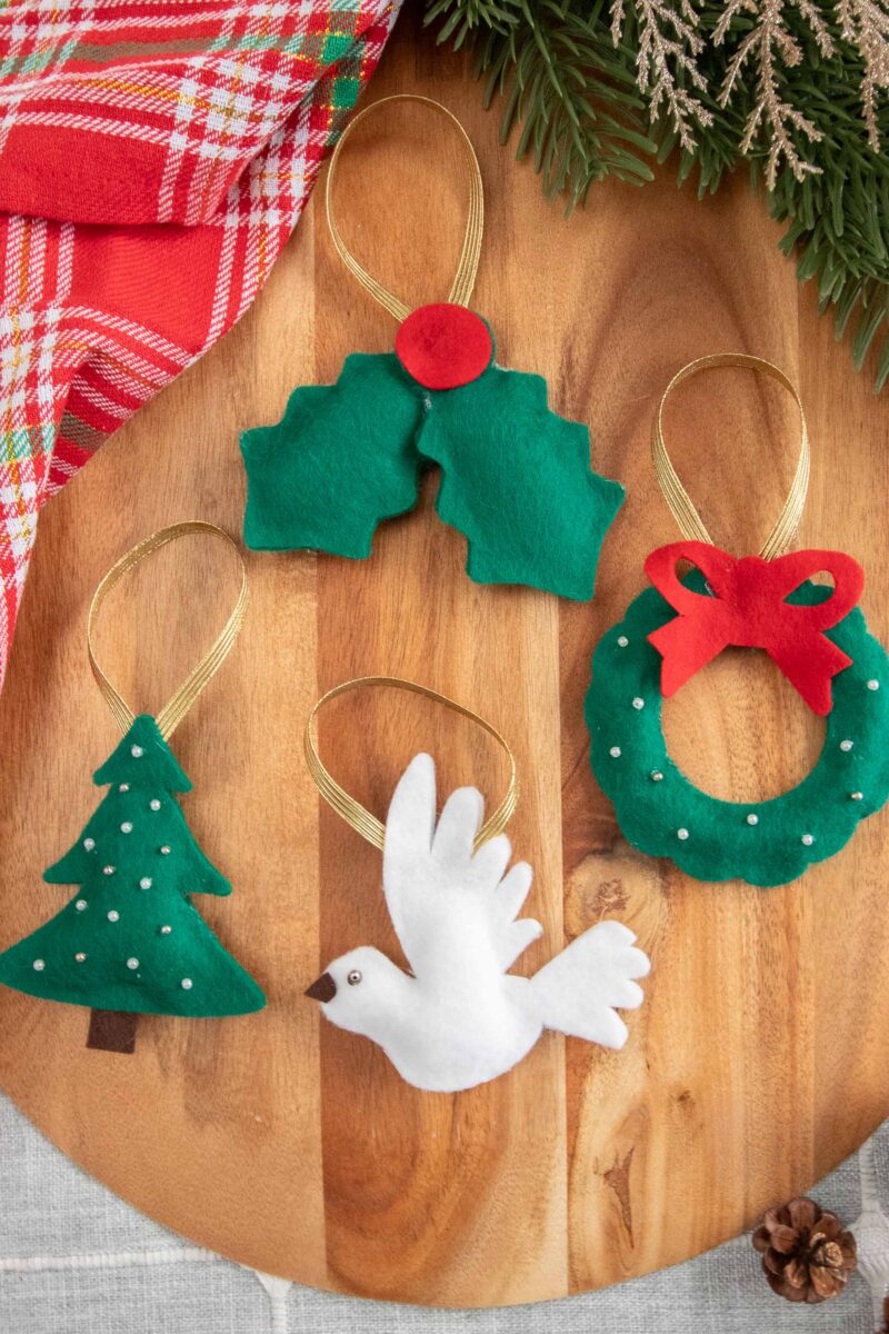 DIY Christmas napkin rings arranged on a cutting board.