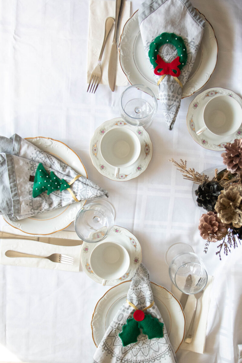 Overhead view of a table set with felt Christmas napkin rings.