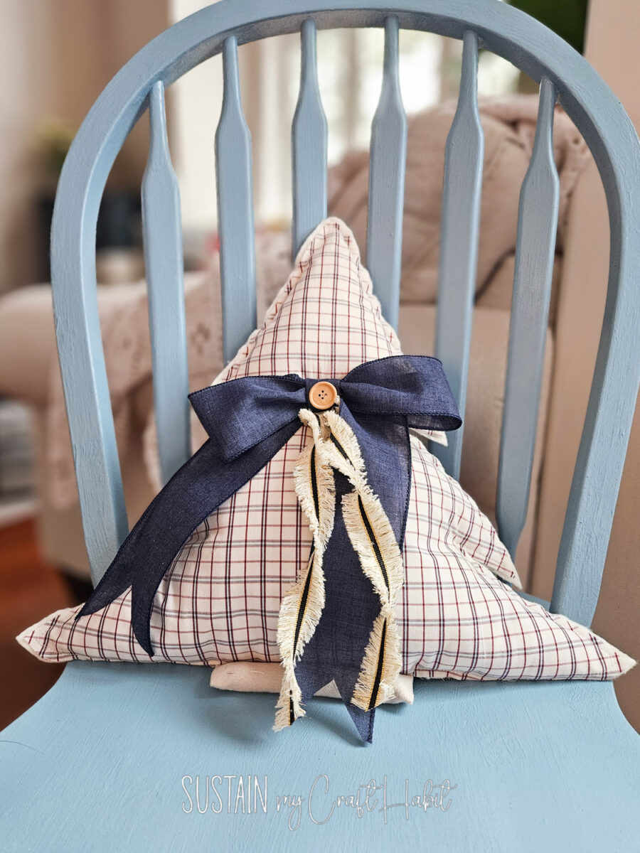 Memory Christmas tree throw pillow on a chair.