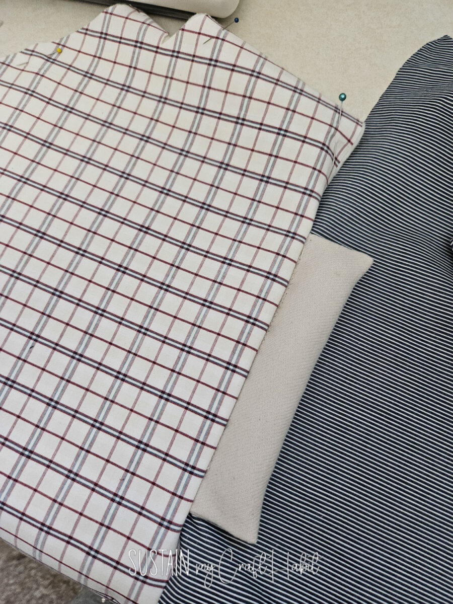Placing stuffed fabric between two pieces of fabric.