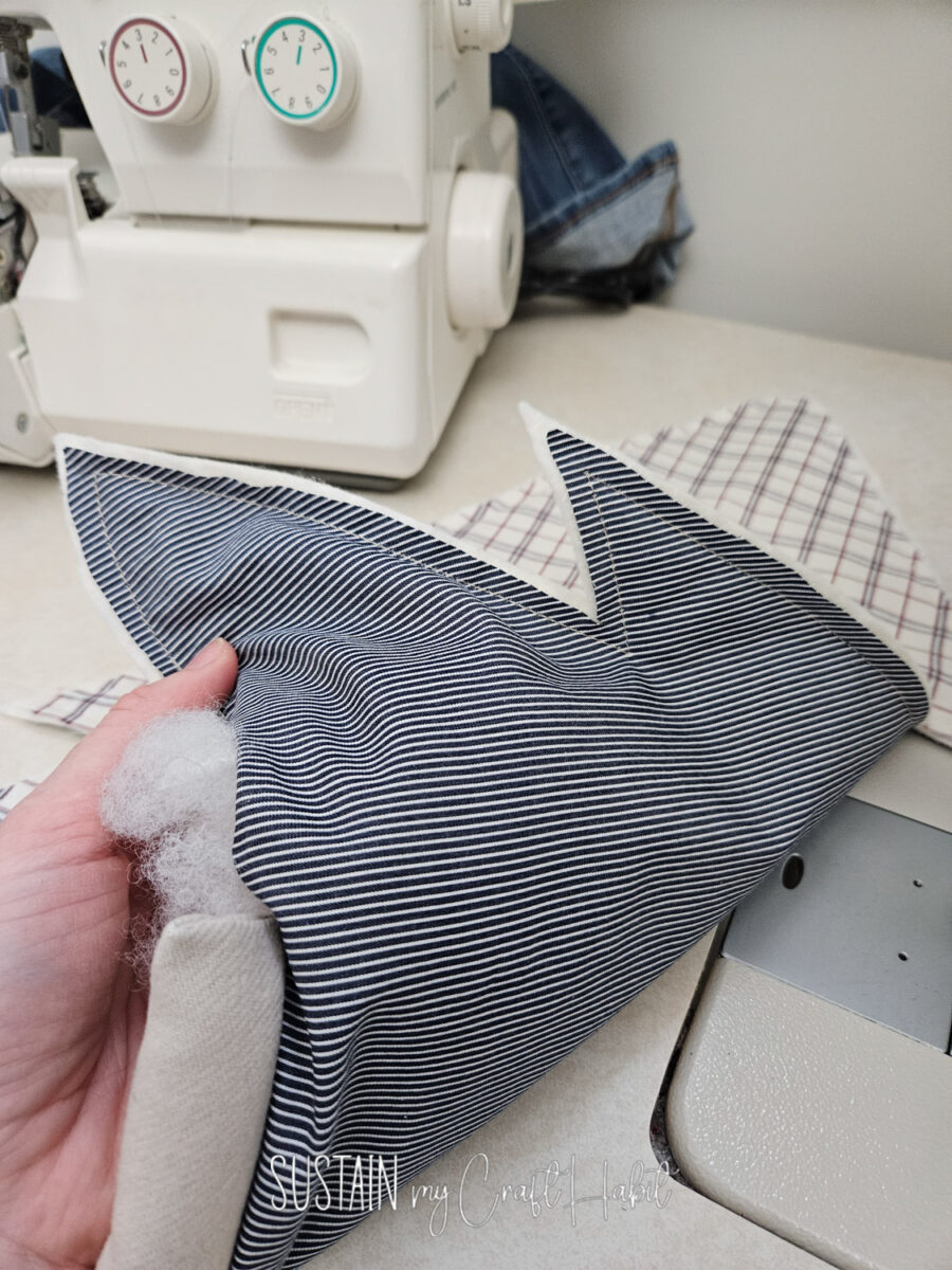 Stuffing polyfill into memory Christmas tree throw pillow.