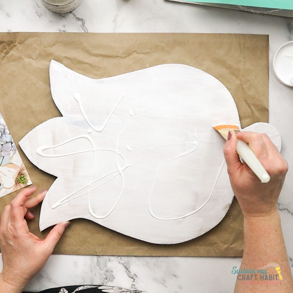 Adding glue to wooden tulip board.