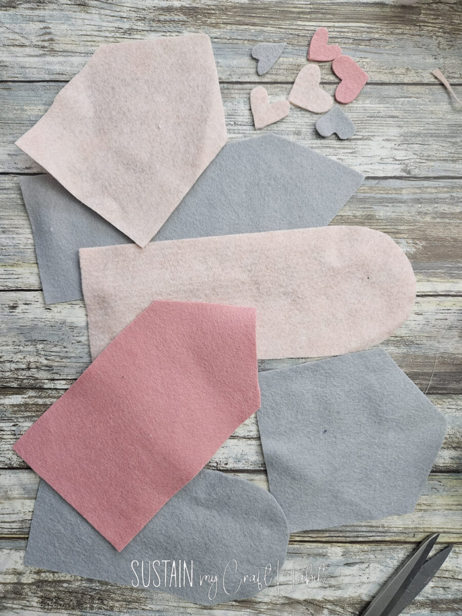 Pieces of felt fabric cut into envelope shapes.