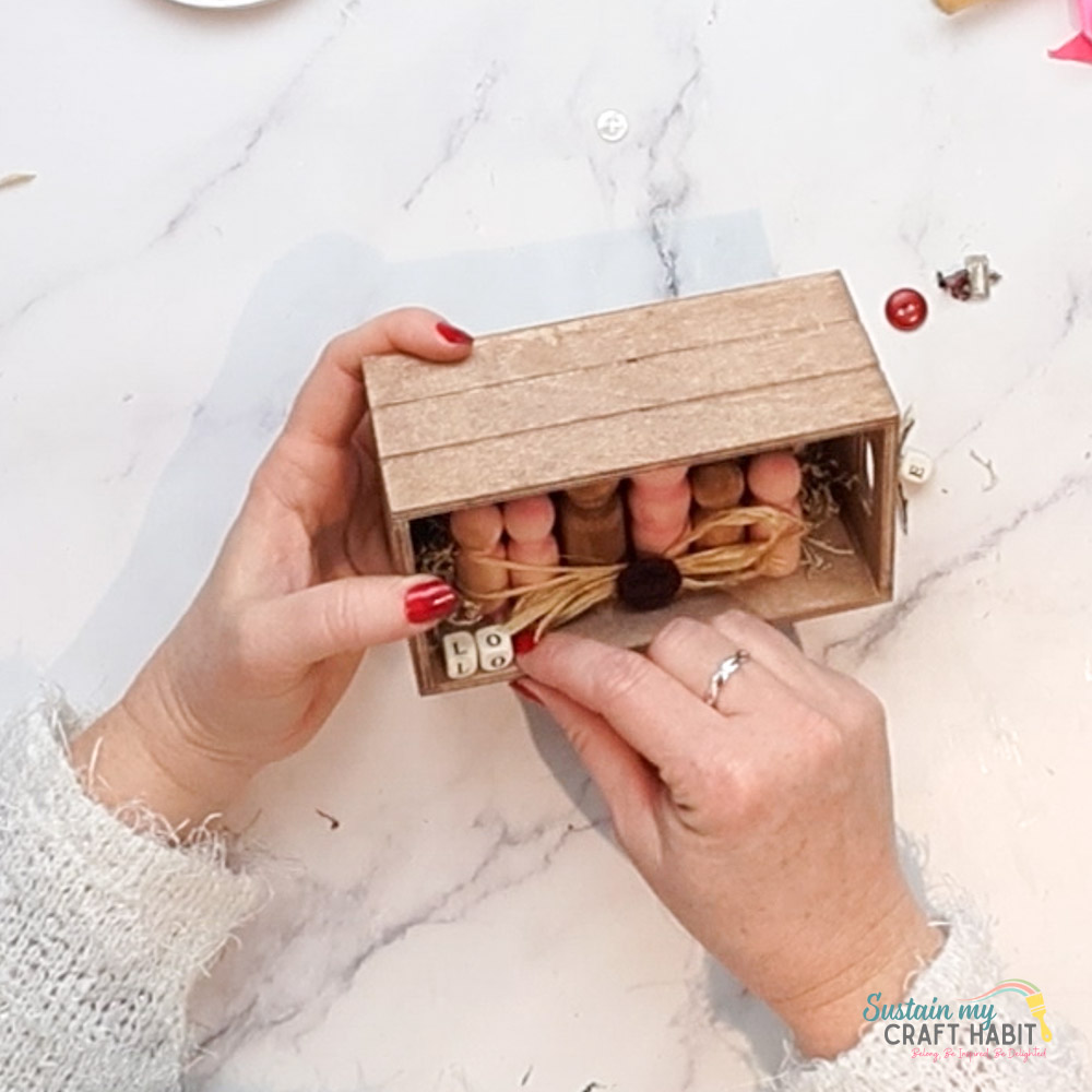 Adding letters to the wooden peg family craft. 