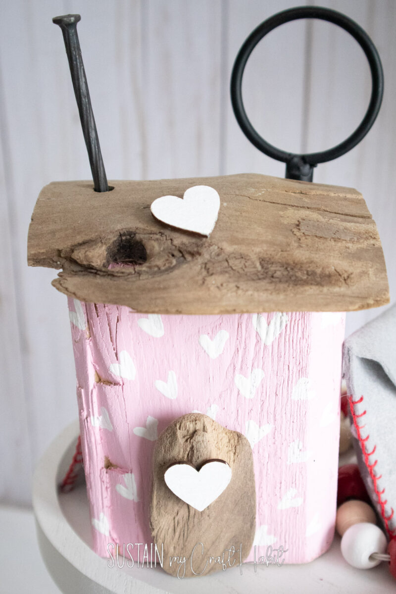 Close up of scrap wood house shelf sitter.