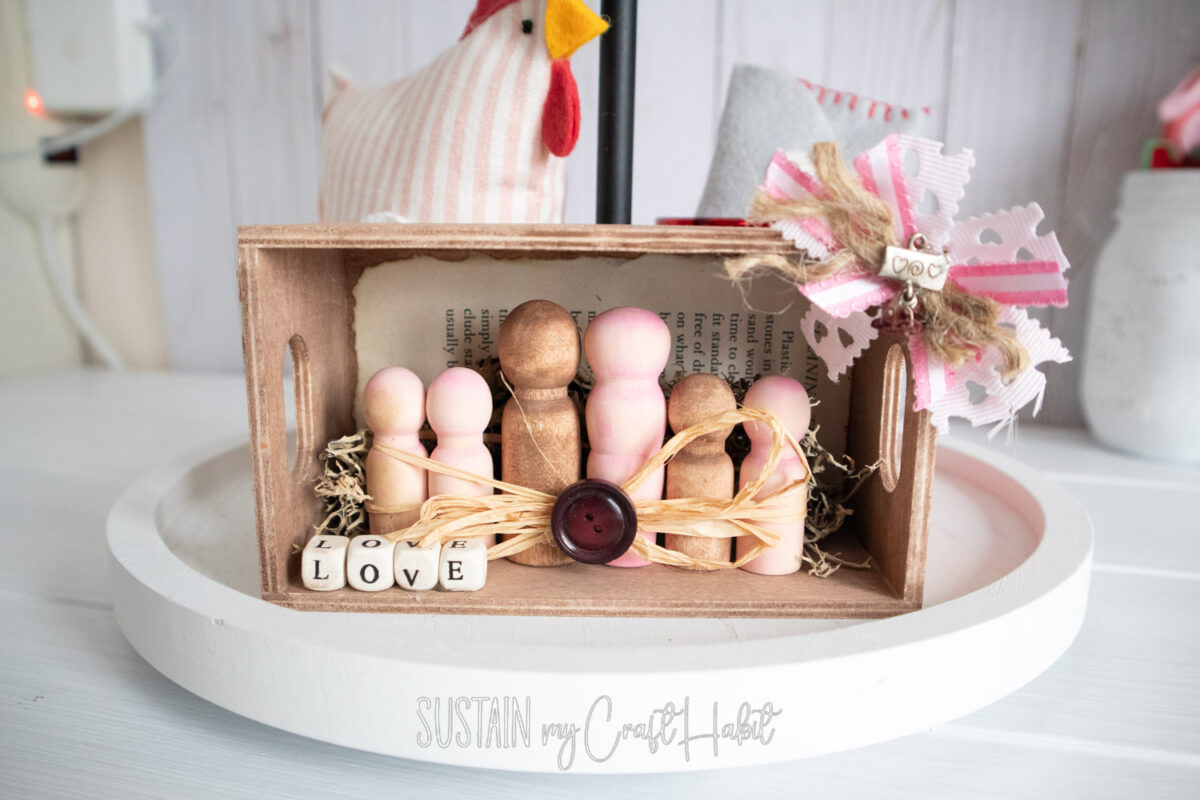 Displayed wood peg family craft.