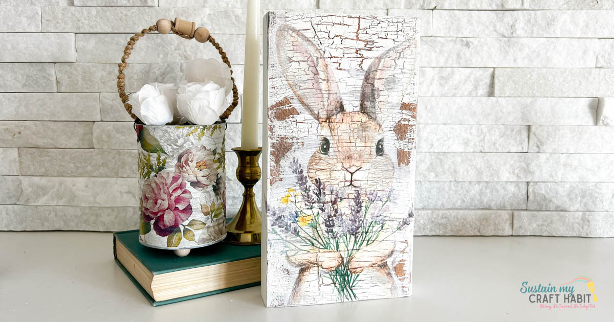 Rustic bunny Easter decoration next to a decorative can, book and candle. 