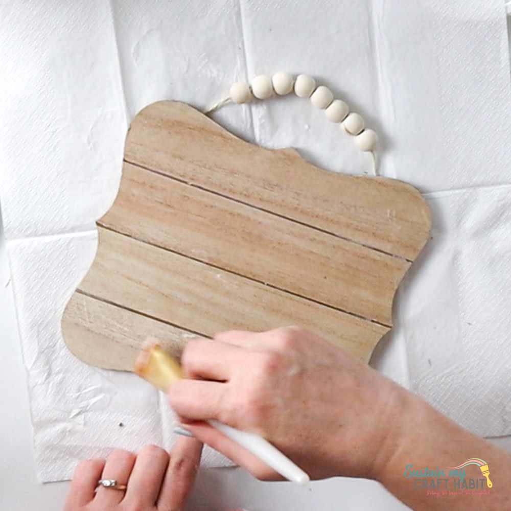 Using a paintbrush to spread glue.