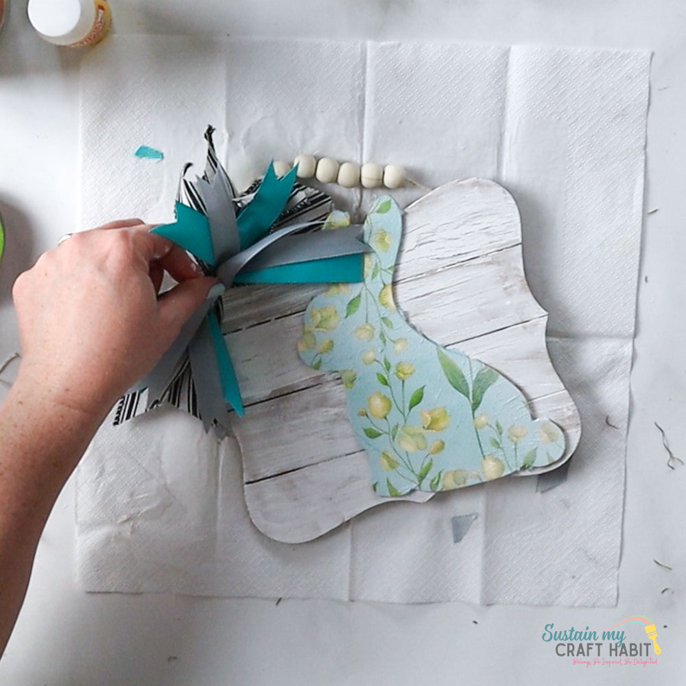 Attaching a messy bow to the bunny sign. 