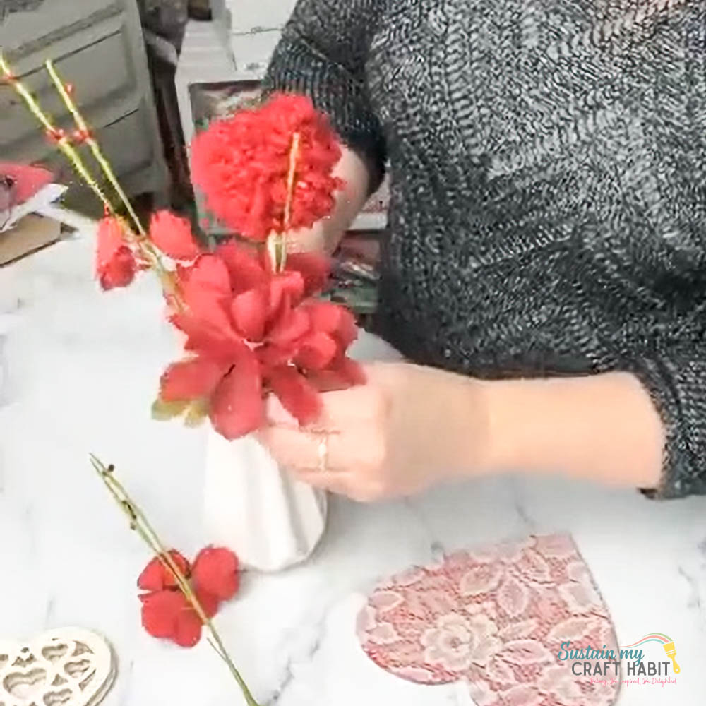 Woman arranging flowers into a case.