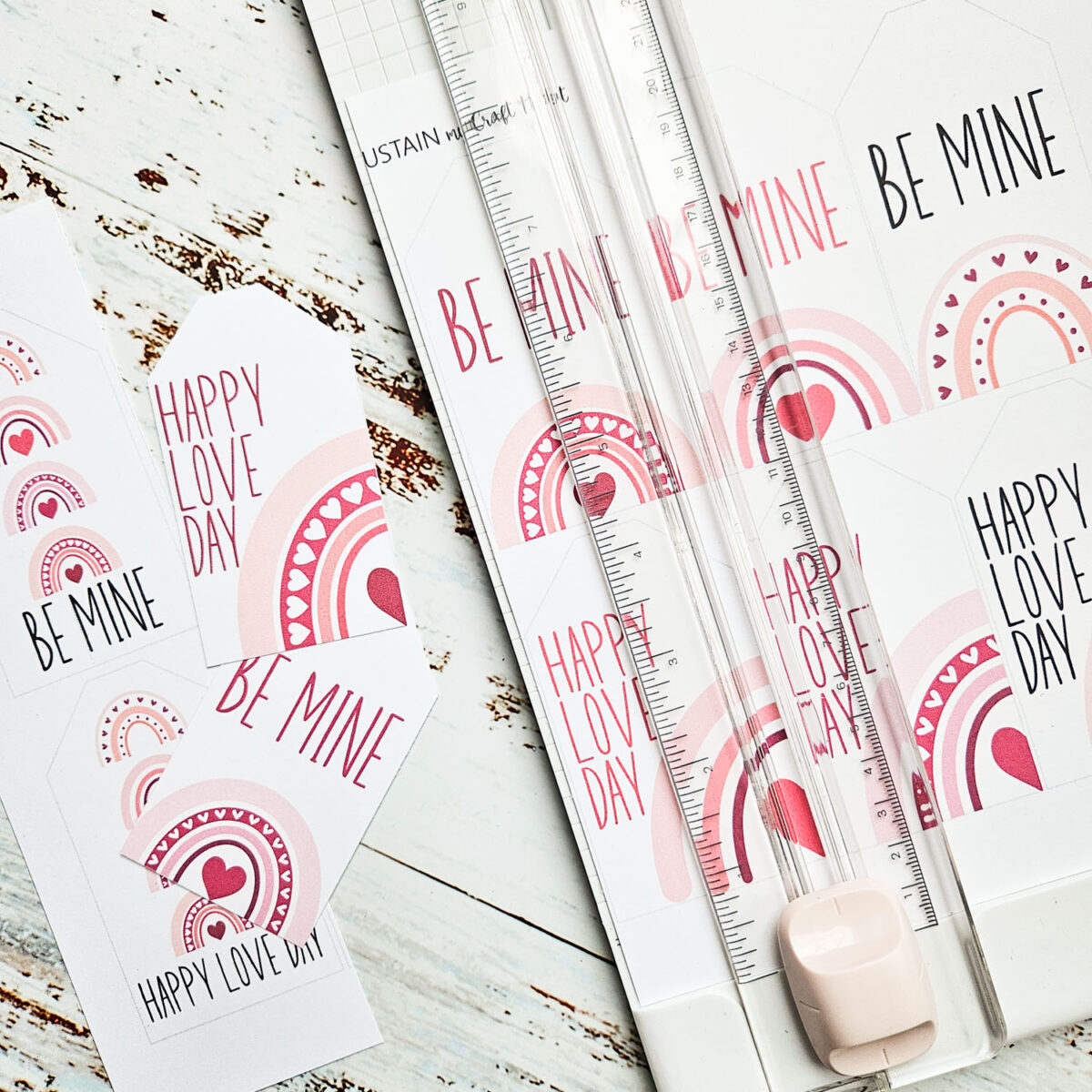 Cutting free printable Valentine's day gift tags into smaller pieces.