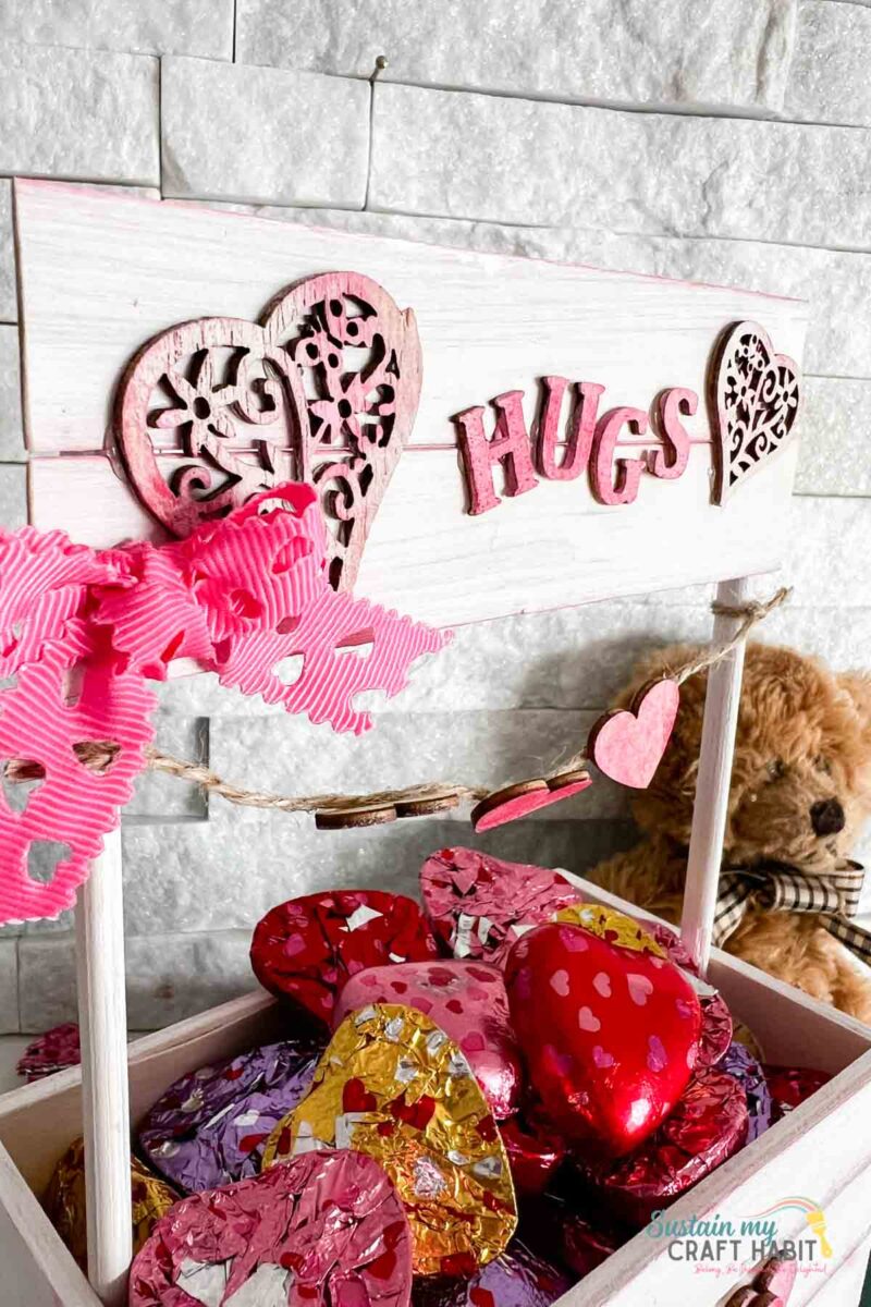 Close up of painted hearts and "hugs" word.