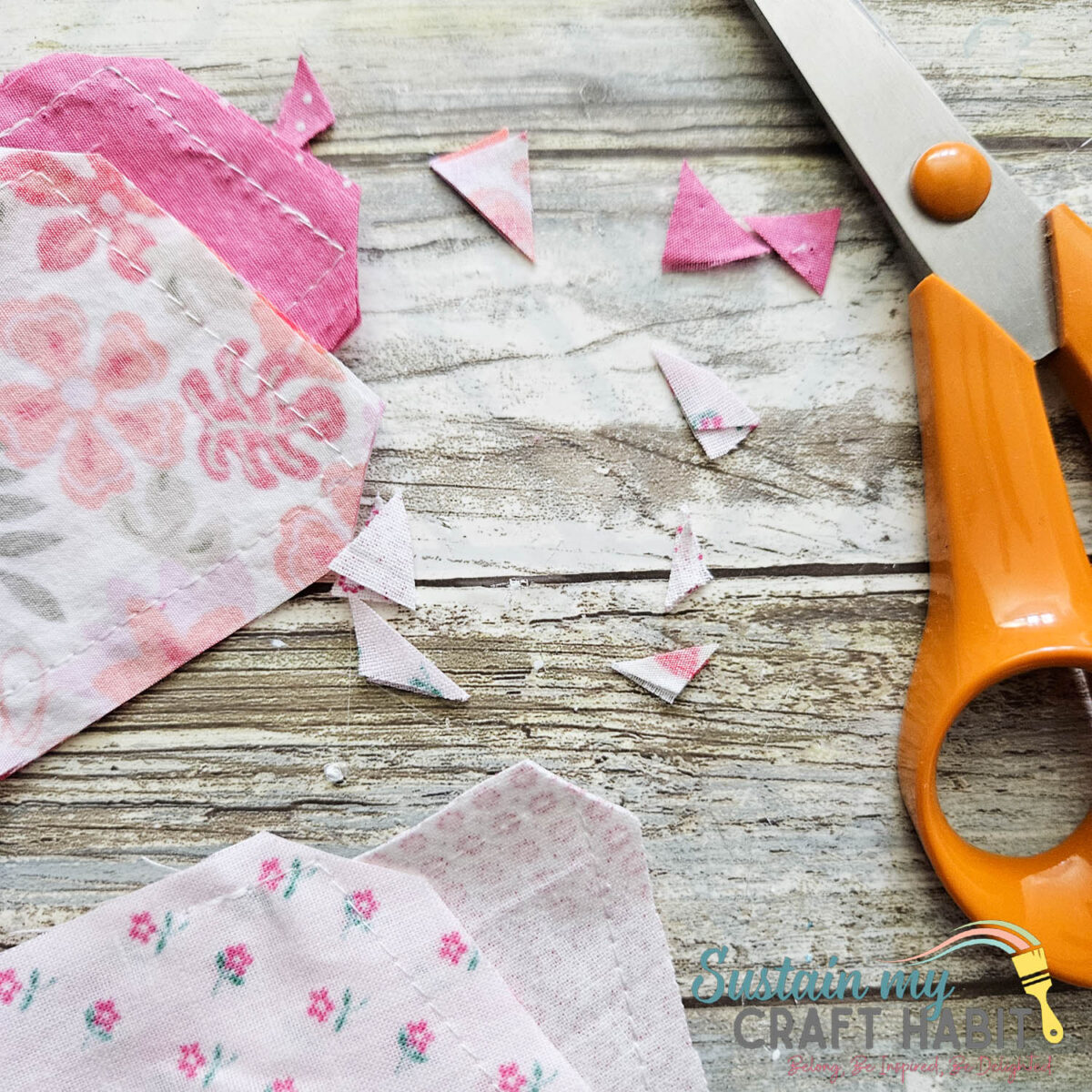 Cutting excess fabric pieces.