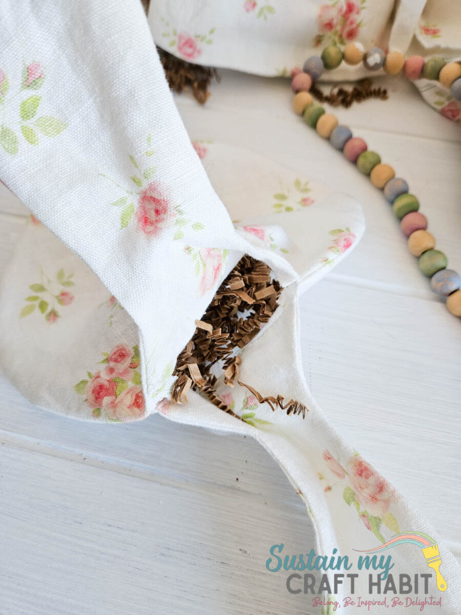 Stuffing Easter bunny gift bag with paper.