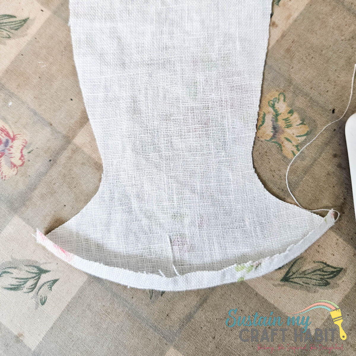 Folding and ironing edge of fabric.