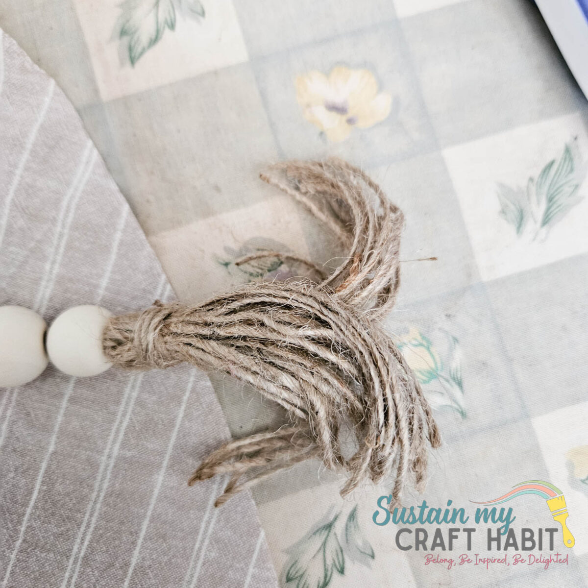 Wrapping twine around the end of twine garland. 