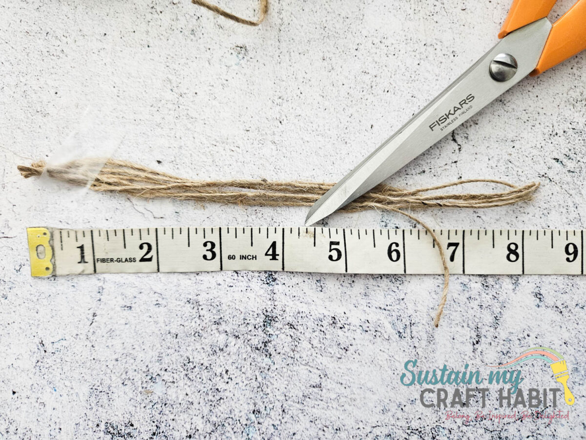Measuring and cutting 8" long pieces of twine. 