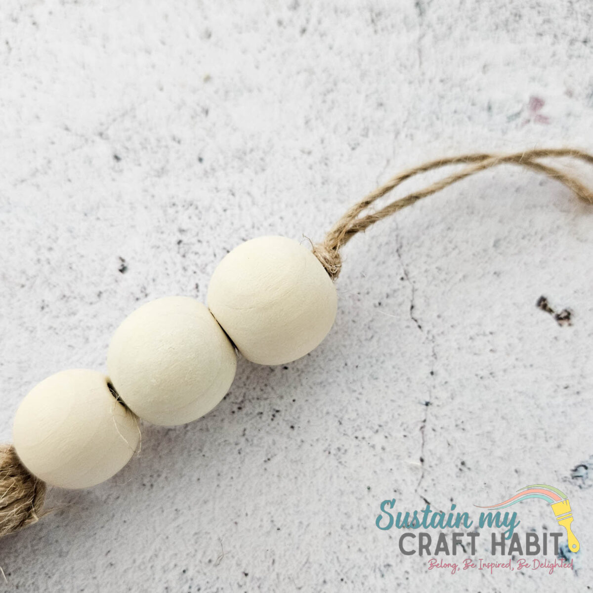 Stringing wood beads onto twine. 