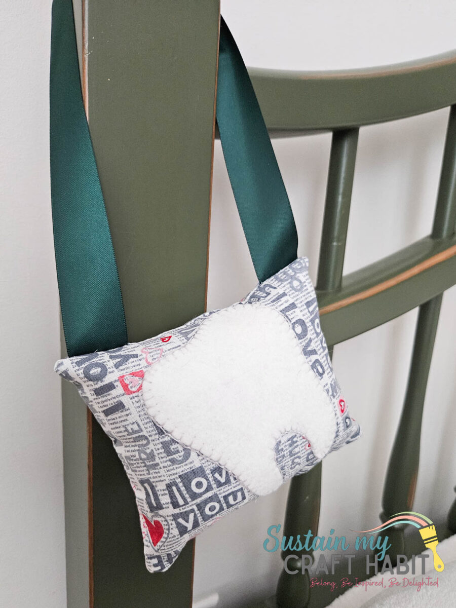 Toothfairy pillow hanging on a chair.