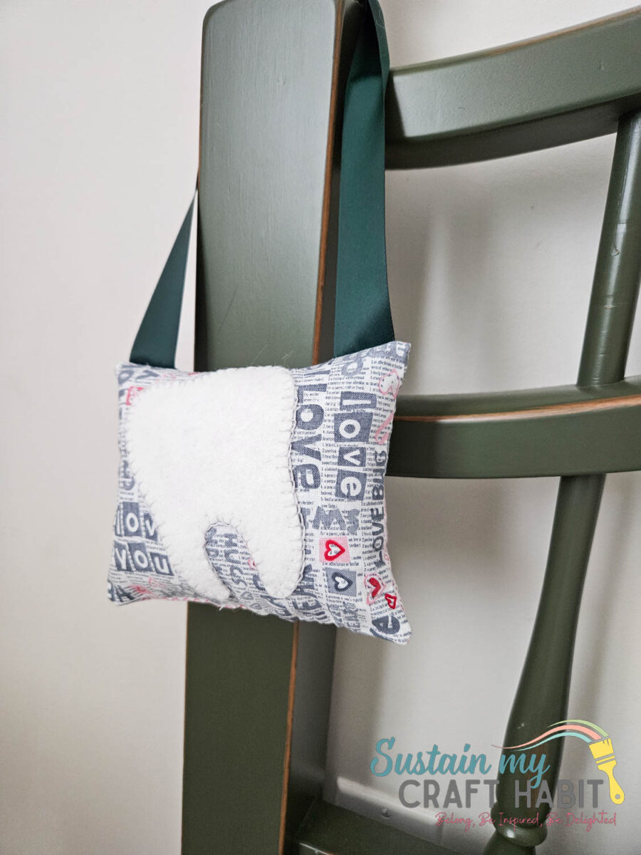 Toothfairy pillow hanging on a chair.