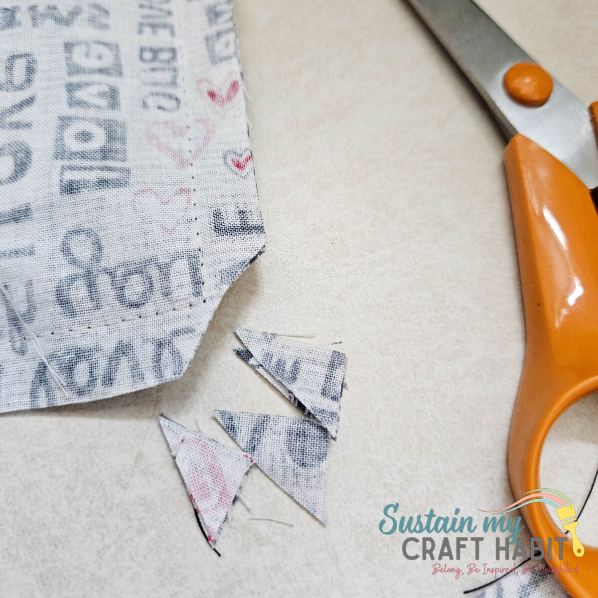 Cutting pieces of excess fabric. 