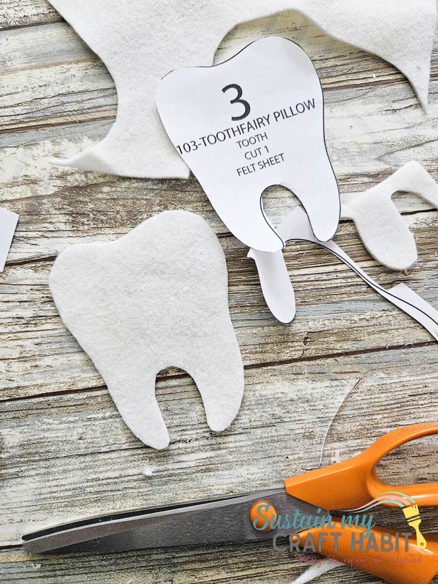 Printable tooth fairy pillow pattern next to cut felt fabric. 